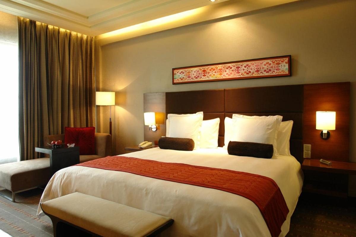 a bedroom with a large bed in a hotel room at Crowne Plaza Today Gurugram by IHG in Gurgaon
