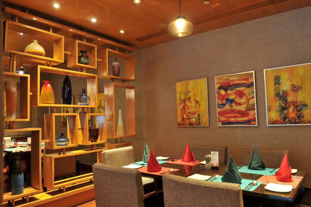 a restaurant with a table with red paper cones on it at Crowne Plaza Today Gurugram by IHG in Gurgaon
