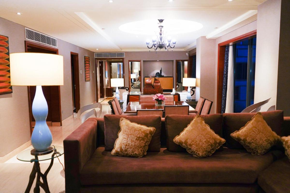 a living room with a couch and a dining room at Crowne Plaza Today Gurugram by IHG in Gurgaon