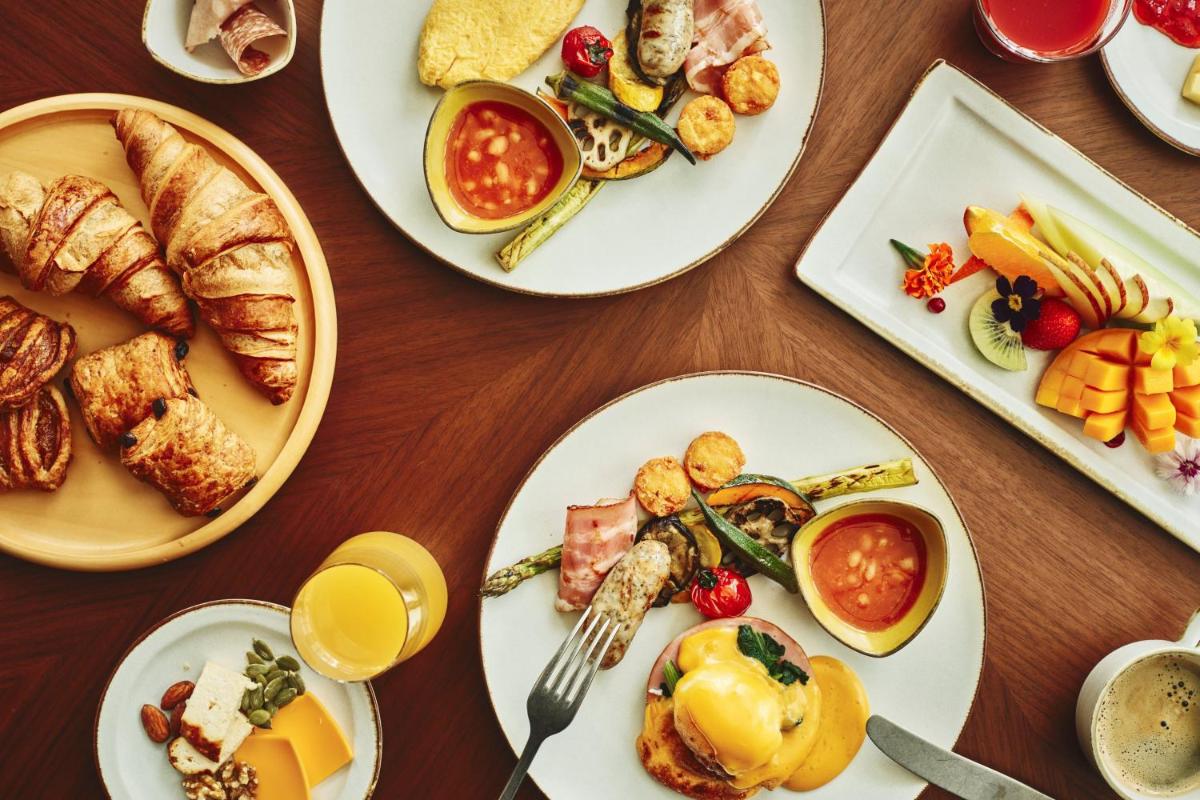 a wooden table with plates of food on it at Crowne Plaza Today Gurugram by IHG in Gurgaon