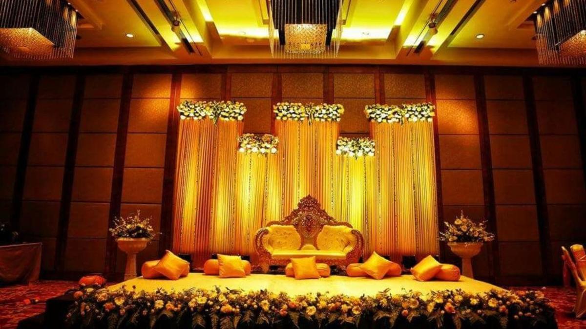 a bed in a room with yellow curtains and flowers at Crowne Plaza Today Gurugram by IHG in Gurgaon