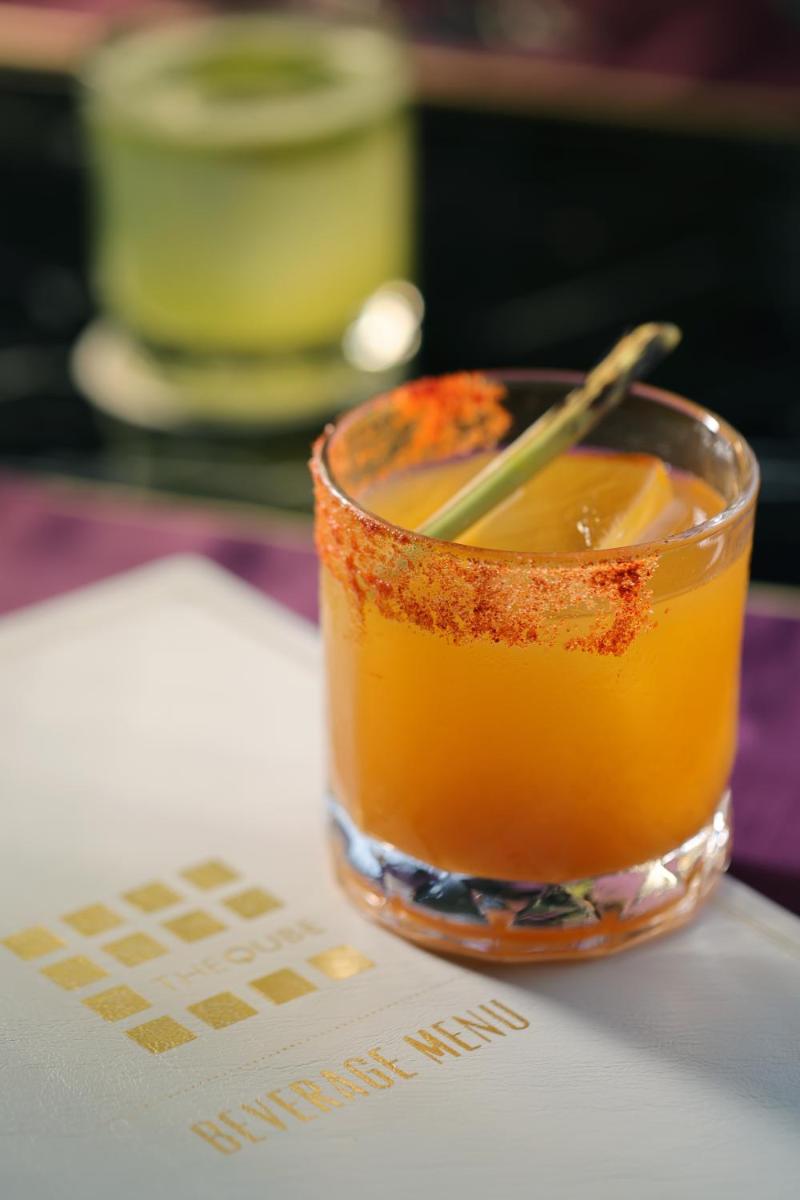 a drink in a glass sitting on a table at The Leela Palace New Delhi in New Delhi a drink in a glass sitting on a table at The Leela Palace New Delhi in New Delhi