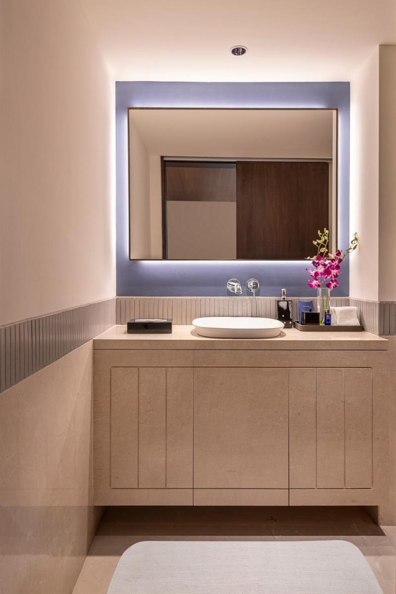 a bathroom with a sink and a mirror at The Oberoi Mumbai in Mumbai