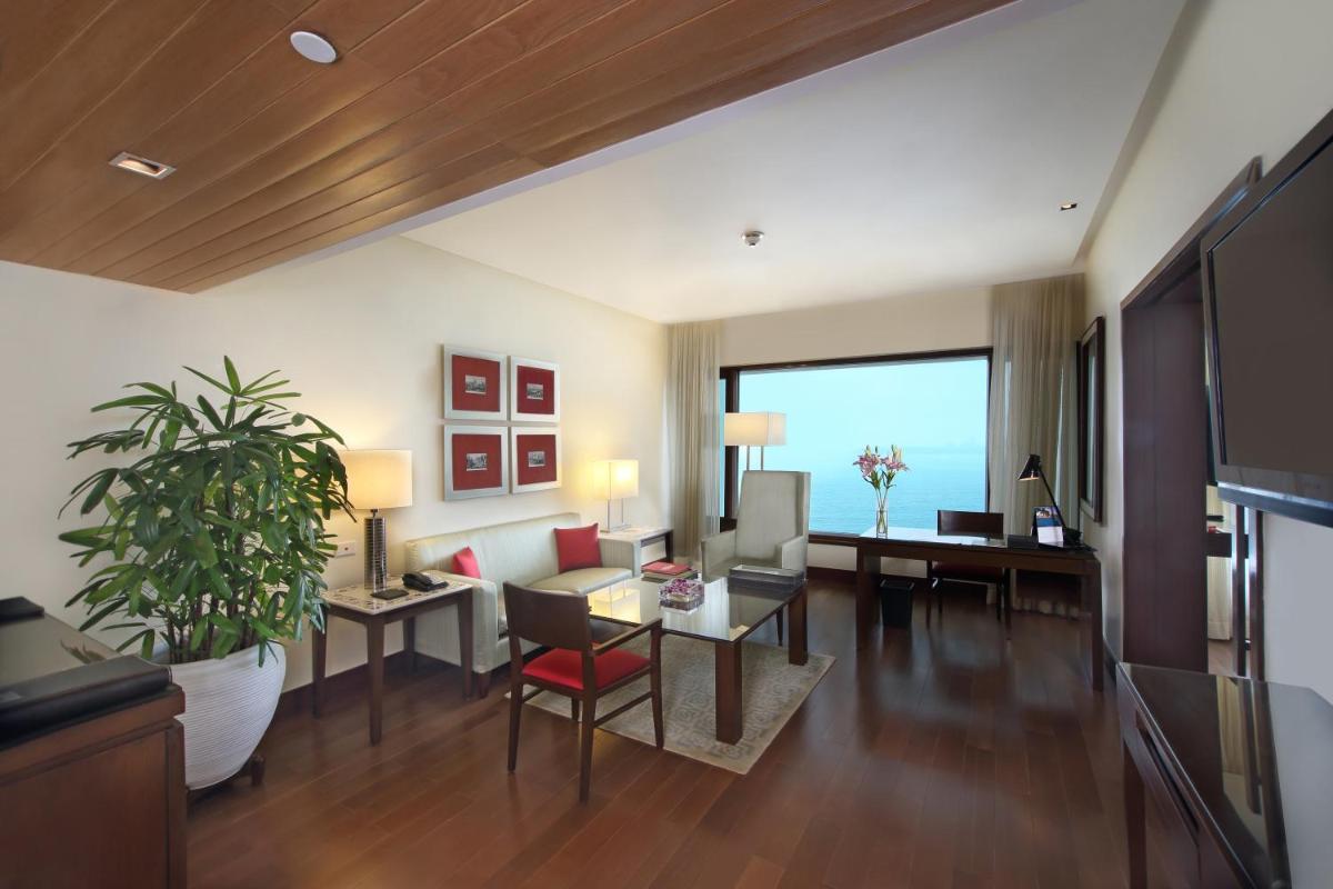 a living room with a couch and a table at The Oberoi Mumbai in Mumbai