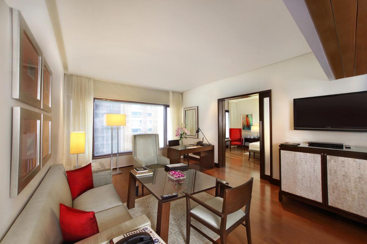 a living room with a couch and a table at The Oberoi Mumbai in Mumbai