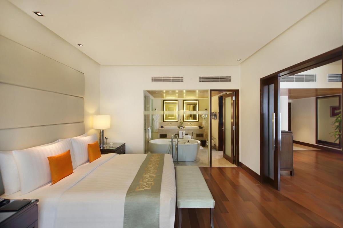 a large bedroom with a large bed and a bathroom at The Oberoi Mumbai in Mumbai