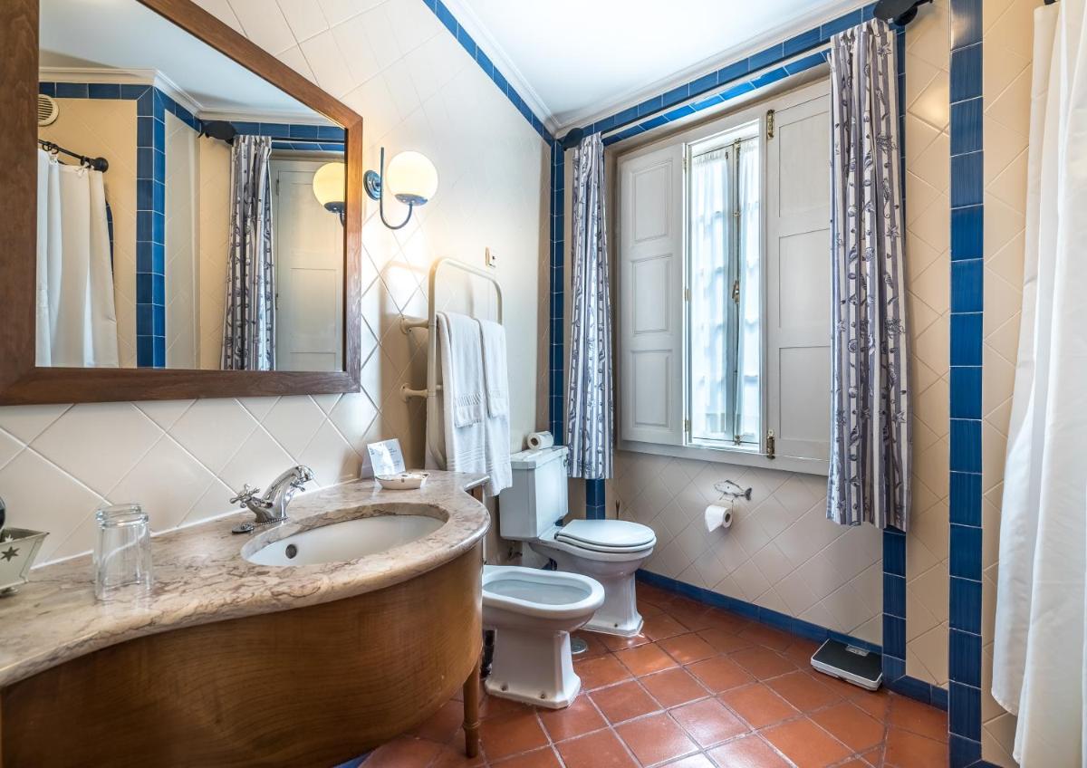 um banheiro com banheira, vaso sanitário e pia em Lawrences Hotel em Sintra