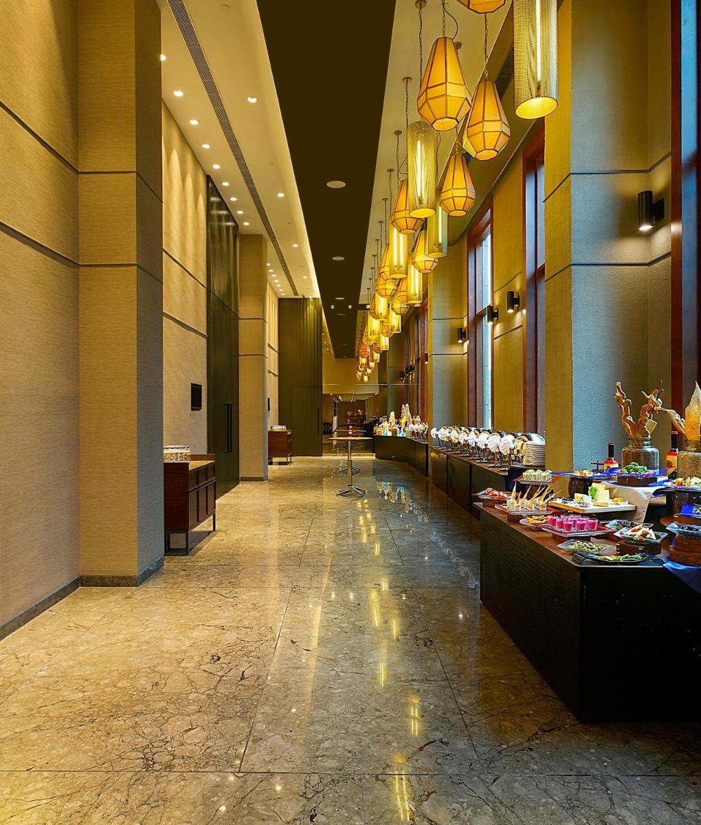 a hallway of a hotel with a buffet line at Grand Mercure Mysore - An Accor Brand in Mysore