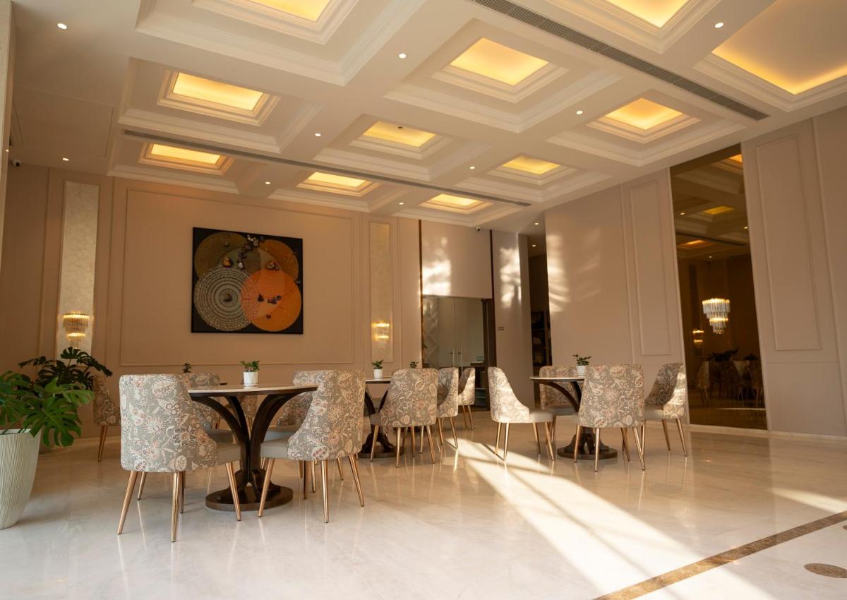 a dining room with tables and chairs in a building at Miros - Formerly Imperial Goa in Old Goa