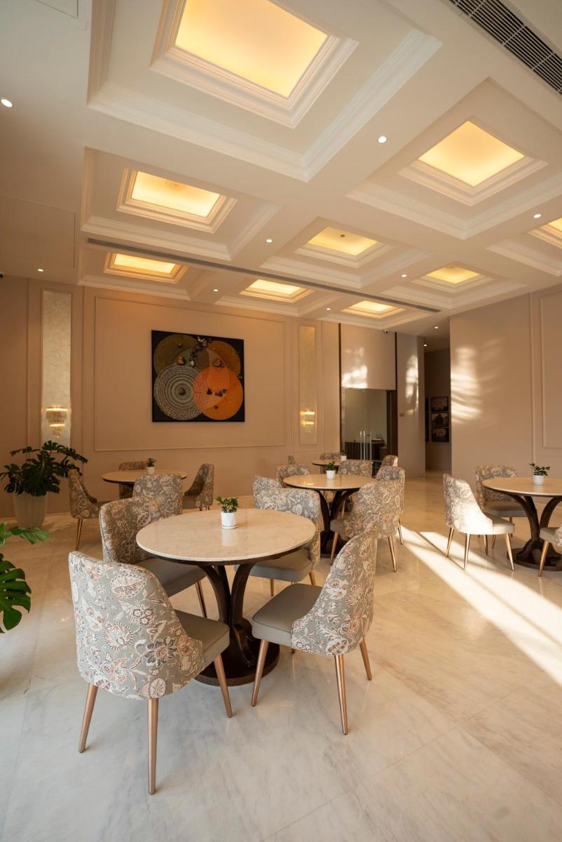 a restaurant with tables and chairs in a room at Miros - Formerly Imperial Goa in Old Goa