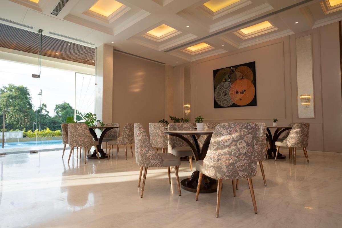 a dining room with a table and chairs at Miros - Formerly Imperial Goa in Old Goa