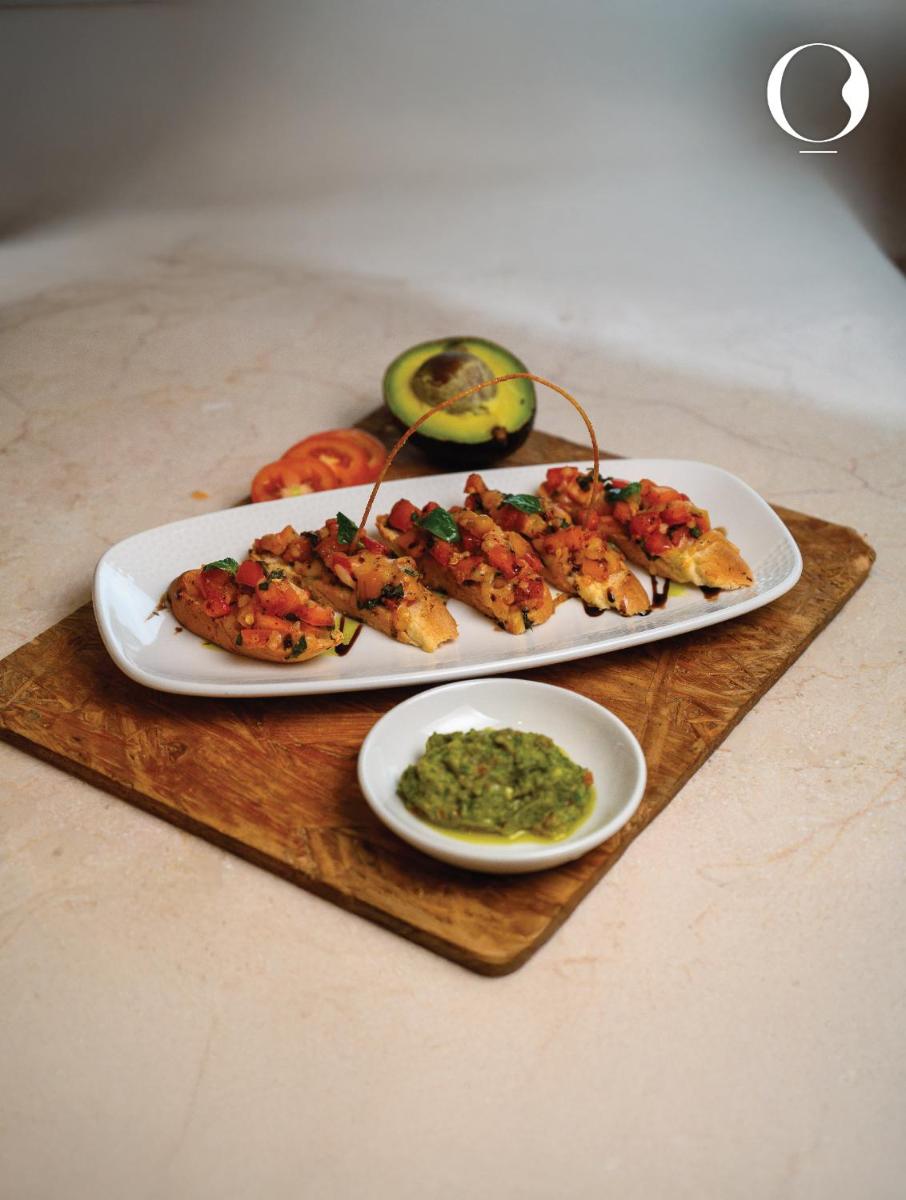 a table with two plates of food on a cutting board at Miros - Formerly Imperial Goa in Old Goa