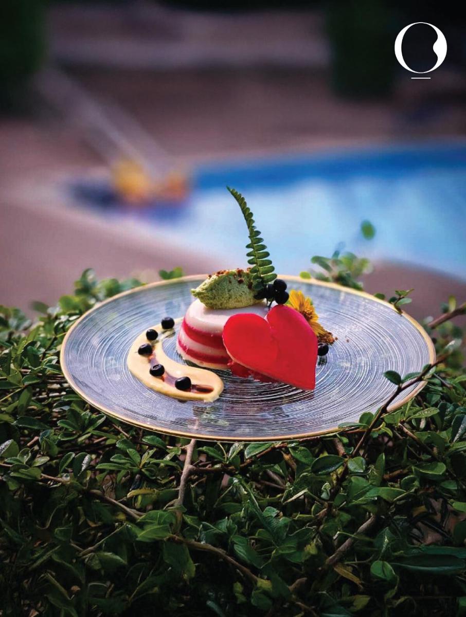 a plate with a dessert on top of a hedge at Miros - Formerly Imperial Goa in Old Goa