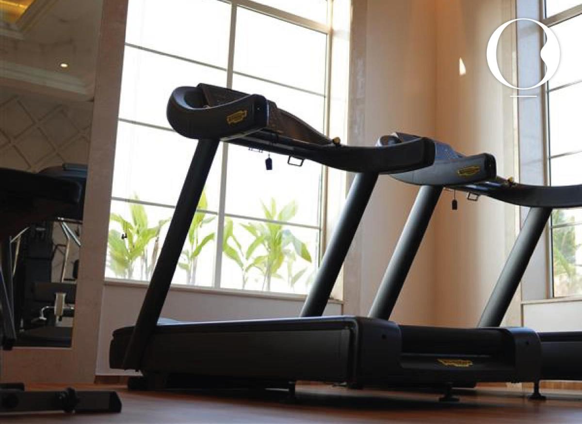 a treadmill in a gym next to a window at Miros - Formerly Imperial Goa in Old Goa