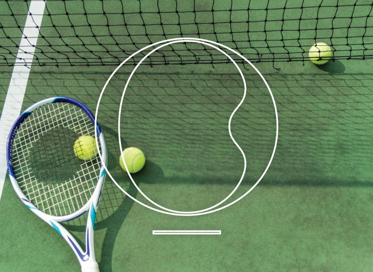 two tennis rackets and two tennis balls on a court at Miros - Formerly Imperial Goa in Old Goa