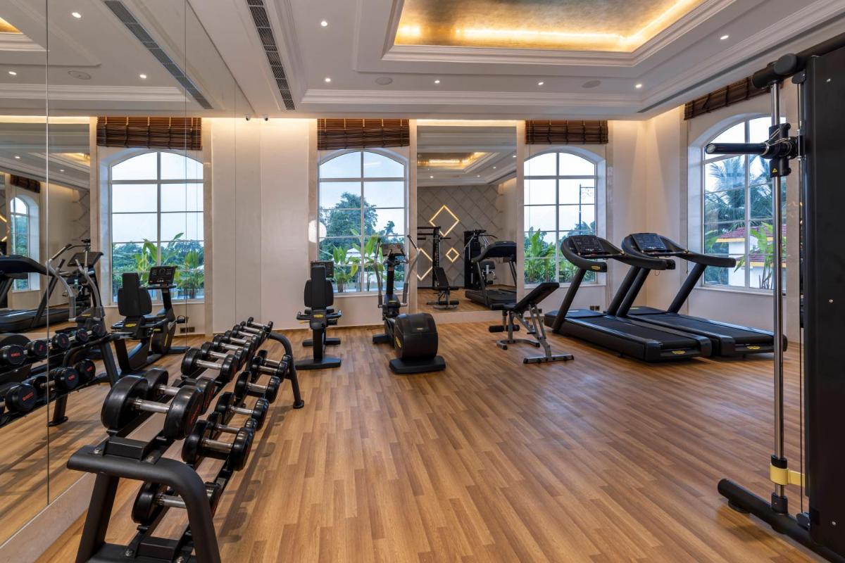 a gym with treadmills and elliptical machines at Miros - Formerly Imperial Goa in Old Goa