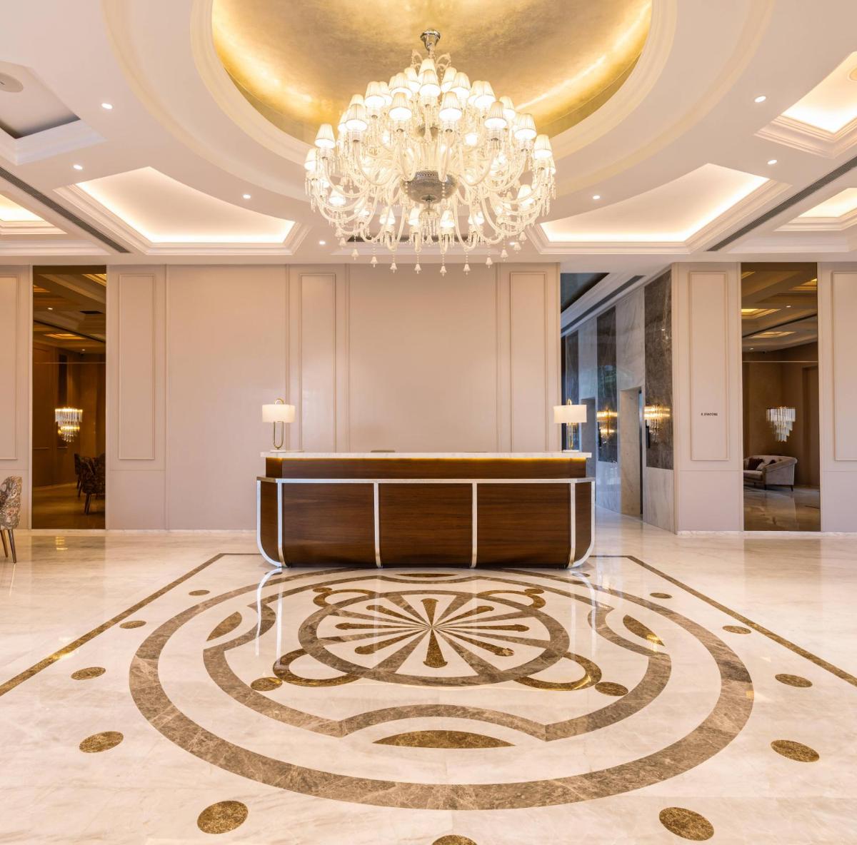 a large lobby with a chandelier and a podium at Miros - Formerly Imperial Goa in Old Goa