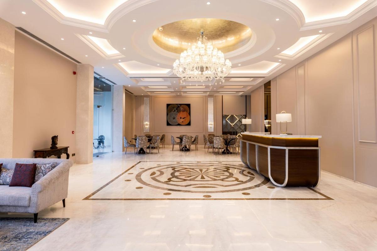 a lobby with a couch and a chandelier at Miros - Formerly Imperial Goa in Old Goa
