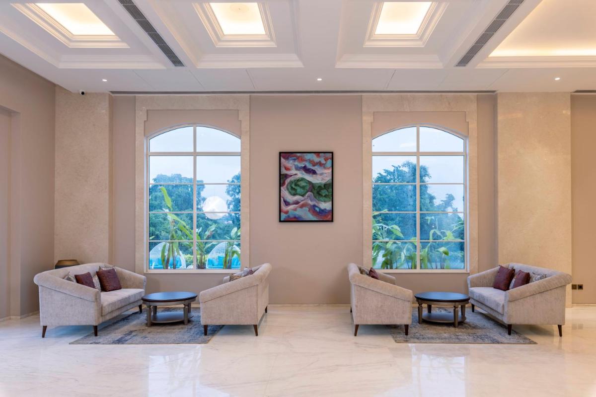 a waiting room with two chairs and two windows at Miros - Formerly Imperial Goa in Old Goa