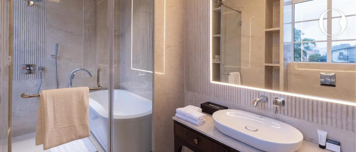 a bathroom with a sink and a toilet and a mirror at Miros - Formerly Imperial Goa in Old Goa