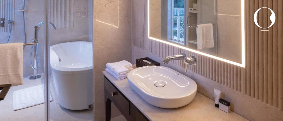a bathroom with a sink and a toilet and a shower at Miros - Formerly Imperial Goa in Old Goa