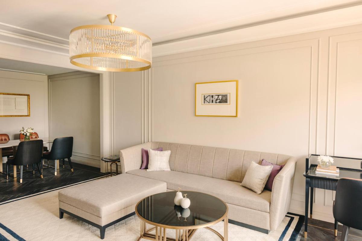 a living room with a couch and a table at Fairmont Mumbai in Mumbai