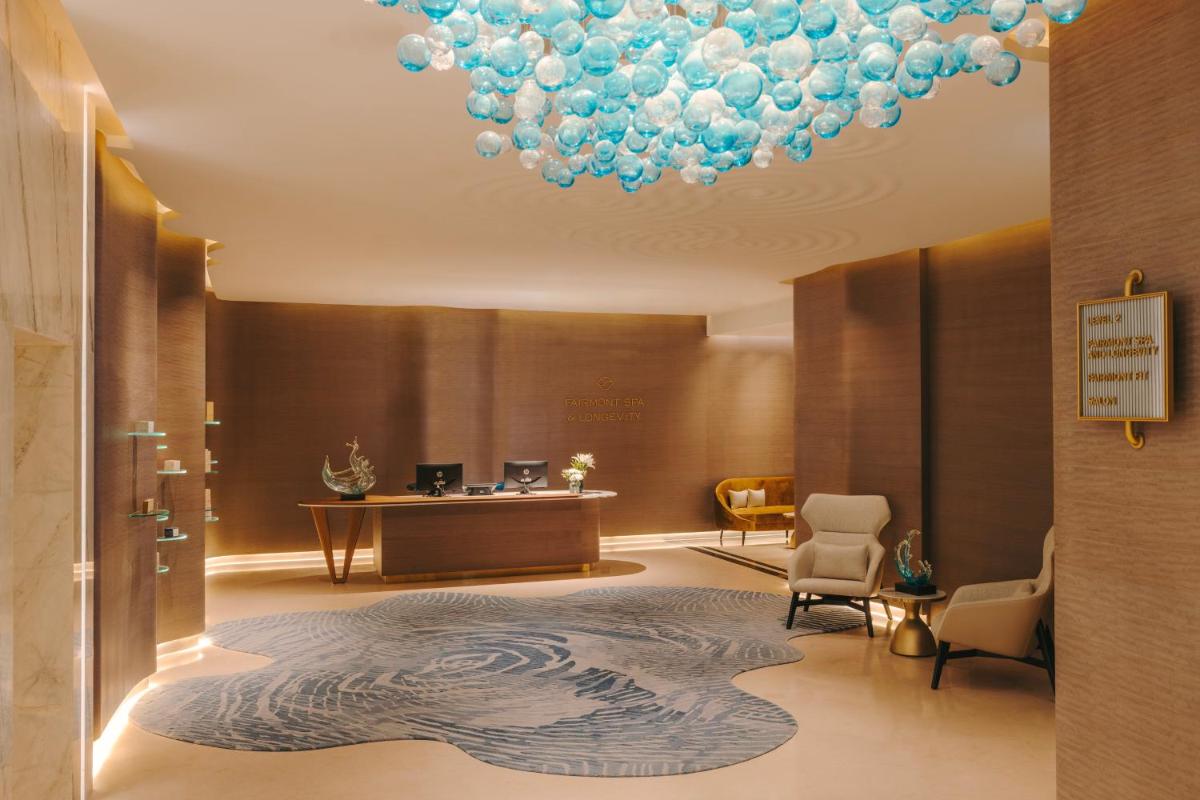 a lobby with a large chandelier and a waiting room at Fairmont Mumbai in Mumbai