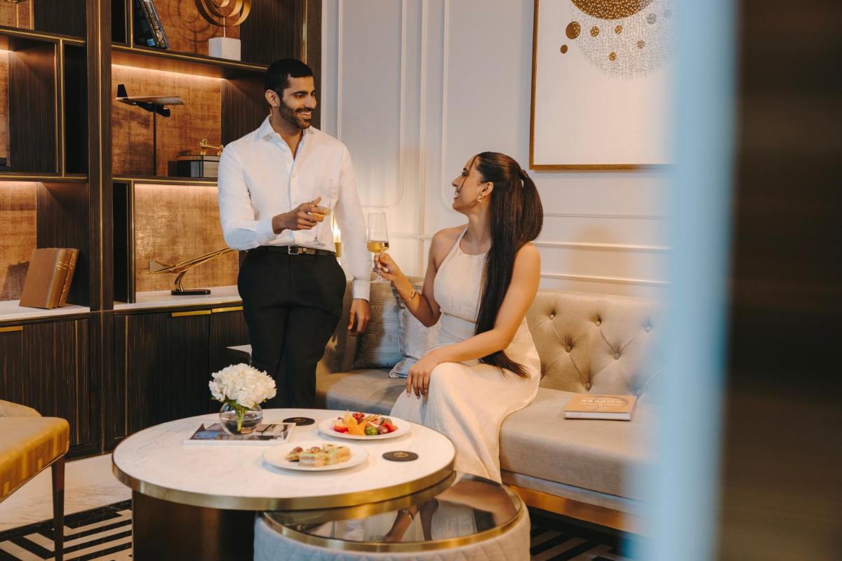 a man and a woman standing in a living room at Fairmont Mumbai in Mumbai