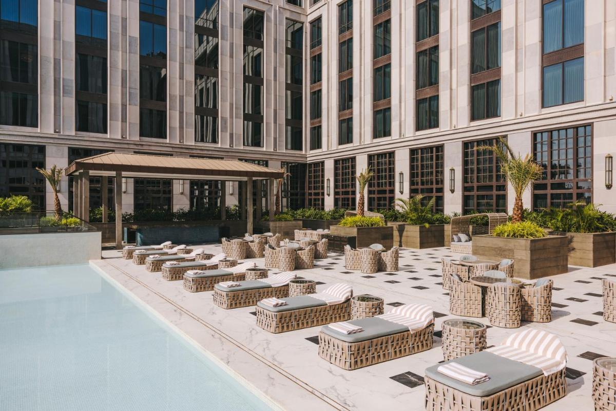 a hotel patio with chairs and a building at Fairmont Mumbai in Mumbai