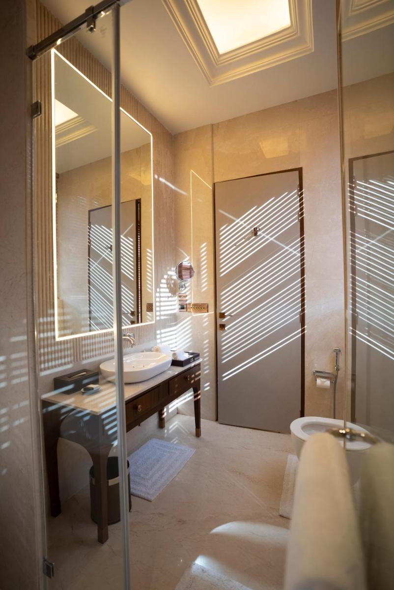 a bathroom with a sink and a mirror at Miros - Formerly Imperial Goa in Old Goa