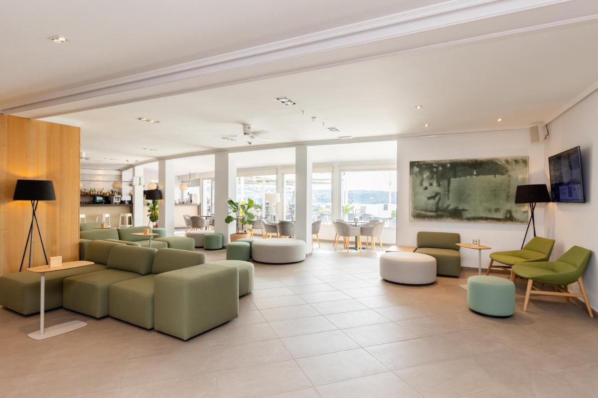 Una sala de estar con sofás, sillas y mesas. en ARTIEM Carlos - Adults Only, en Es Castell