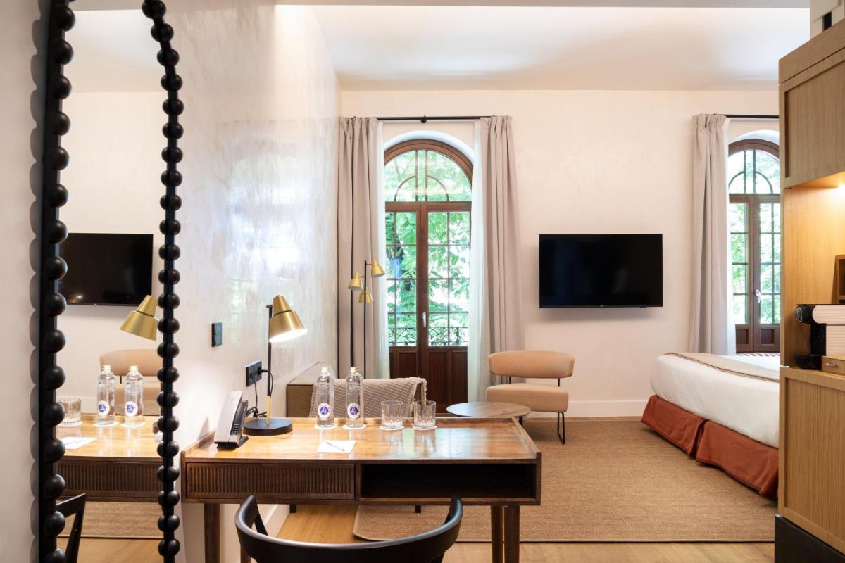 Una televisión o centro de entretenimiento en Cavalta Boutique Hotel - Small Luxury Hotels