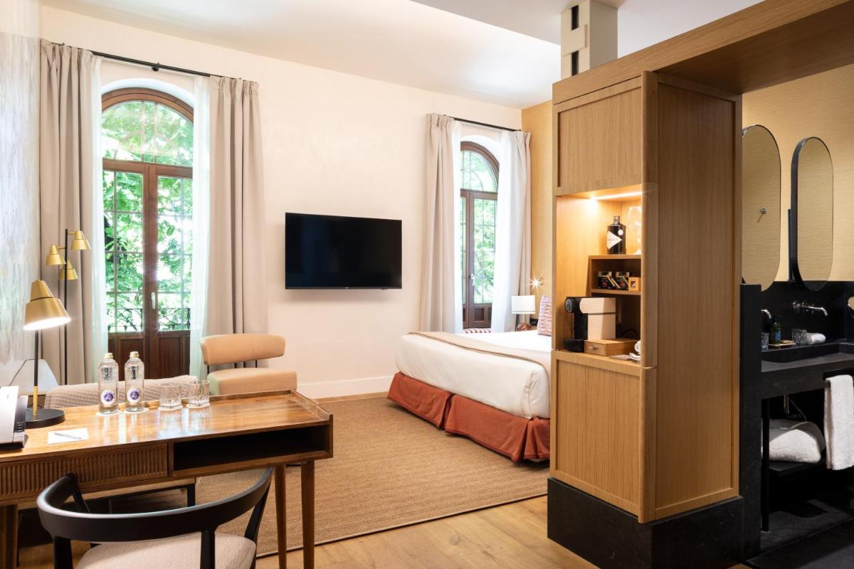 Una televisión o centro de entretenimiento en Cavalta Boutique Hotel - Small Luxury Hotels