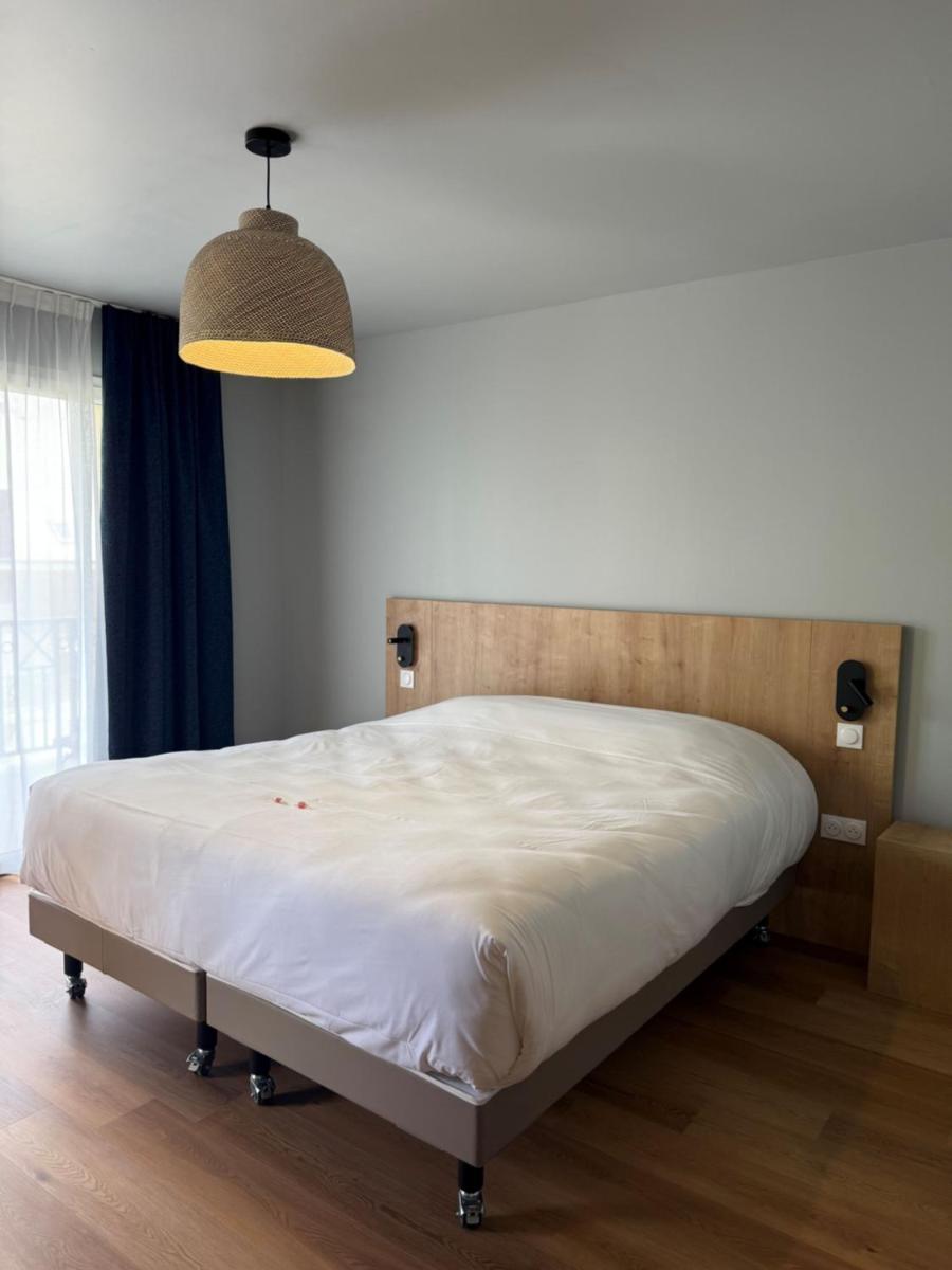 Un ou plusieurs lits dans un hébergement de l'établissement Tulip Inn Honfleur Residence & Spa