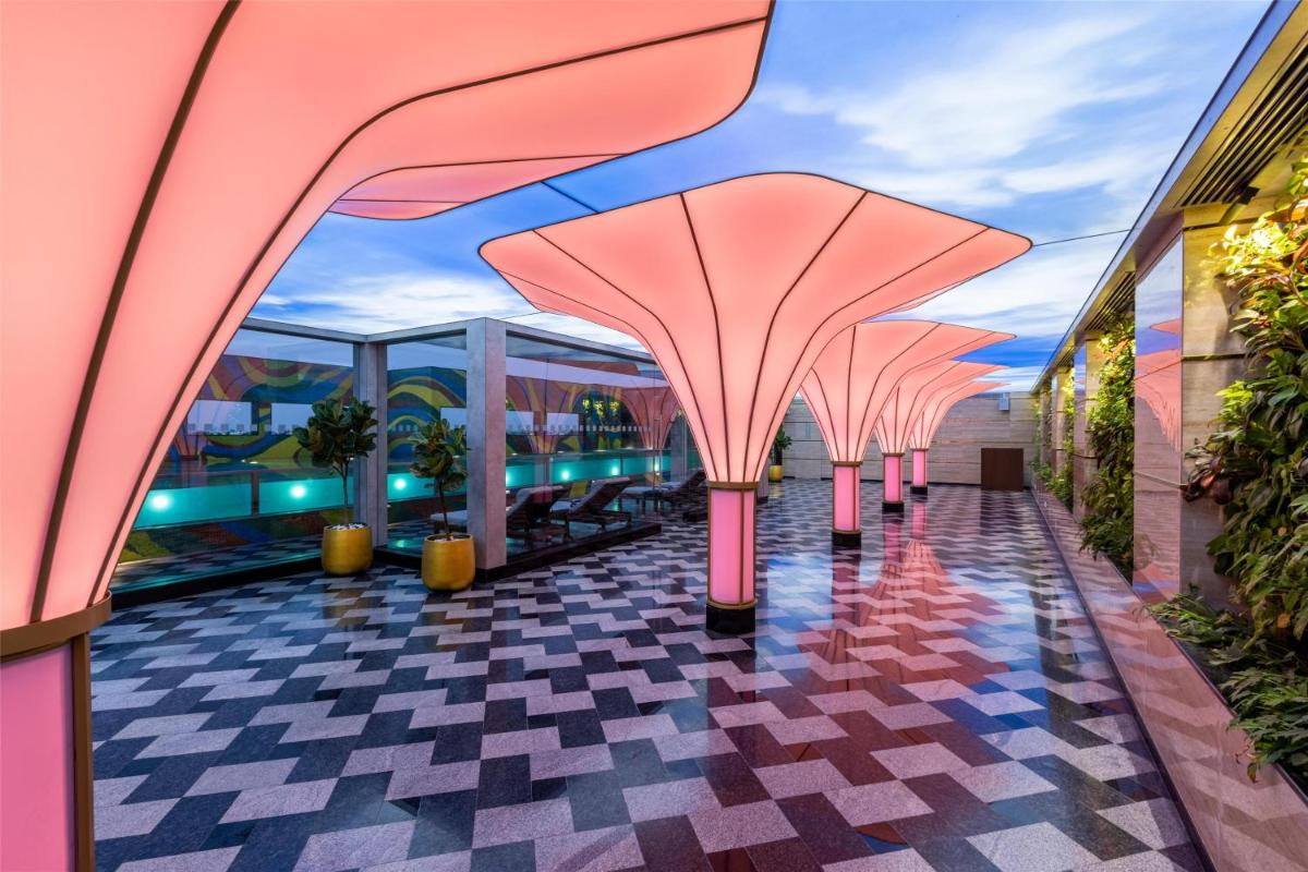 a rendering of a building with pink columns at Radisson Blu Hotel & Suites GRT Chennai in Chennai