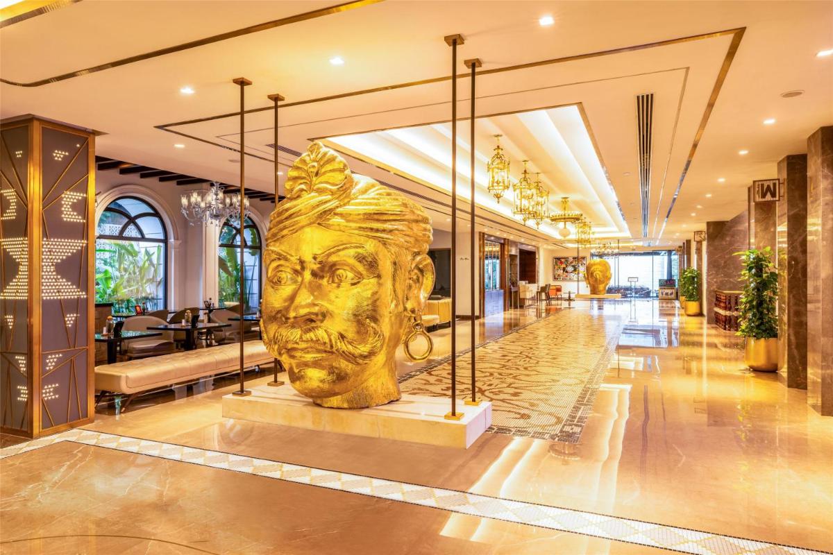 a statue of a face in the middle of a lobby at Radisson Blu Hotel & Suites GRT Chennai in Chennai