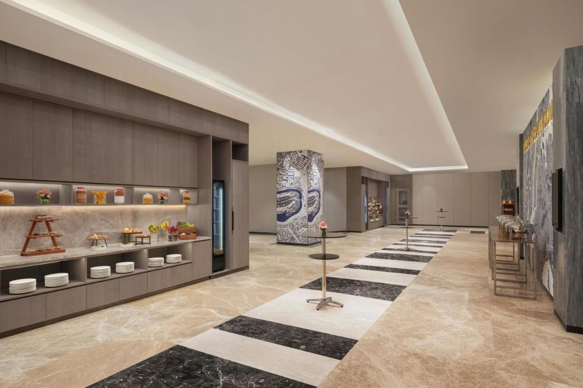 a lobby with a museum with vases on display at Le Meridien Ahmedabad in Ahmedabad