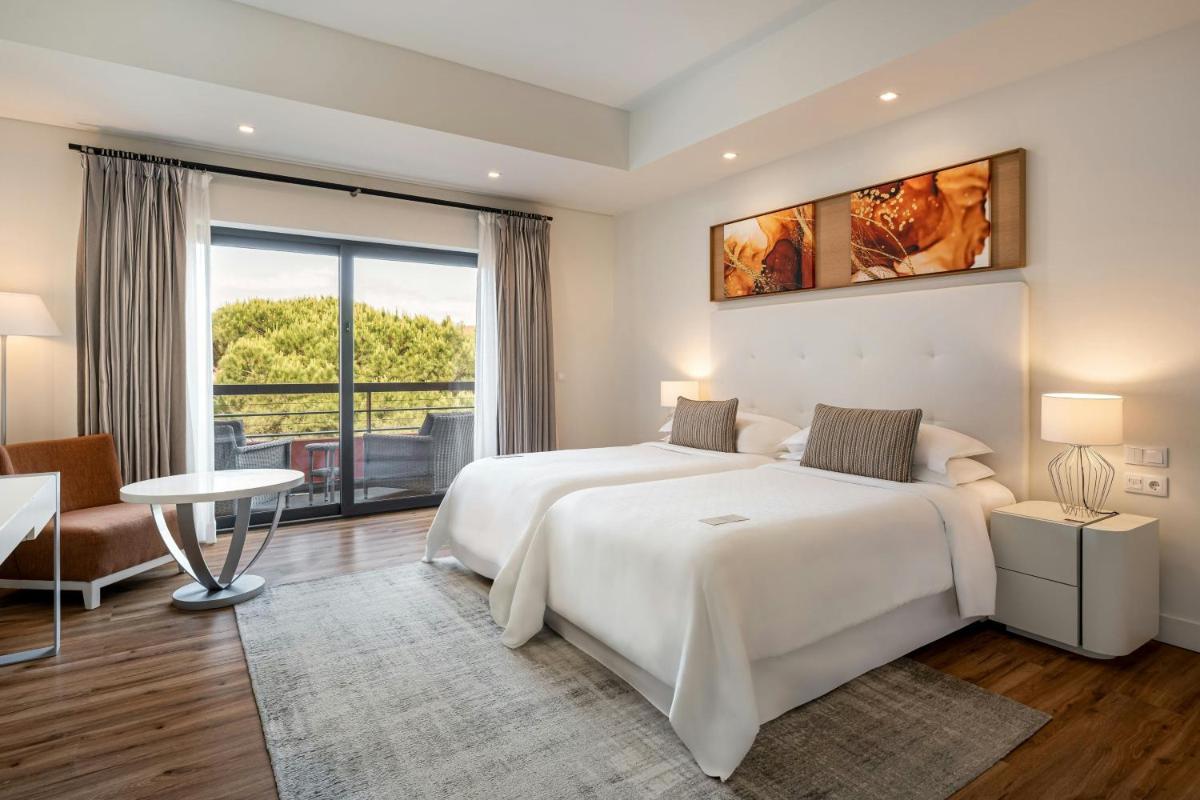Um quarto branco com duas camas e uma janela. em Sheraton Cascais Resort - Hotel & Residences em Cascais