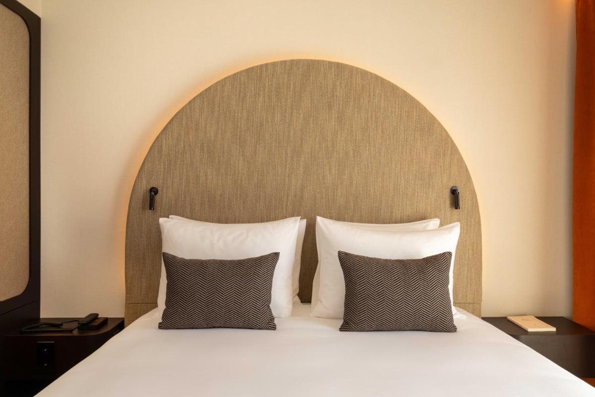 Un ou plusieurs lits dans un hébergement de l'établissement Belinda Hôtel & Spa