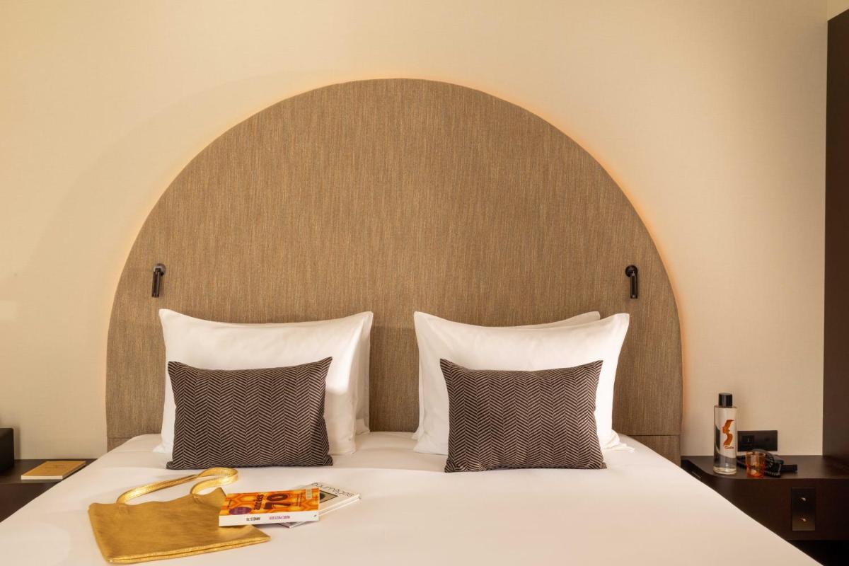 Un ou plusieurs lits dans un hébergement de l'établissement Belinda Hôtel & Spa