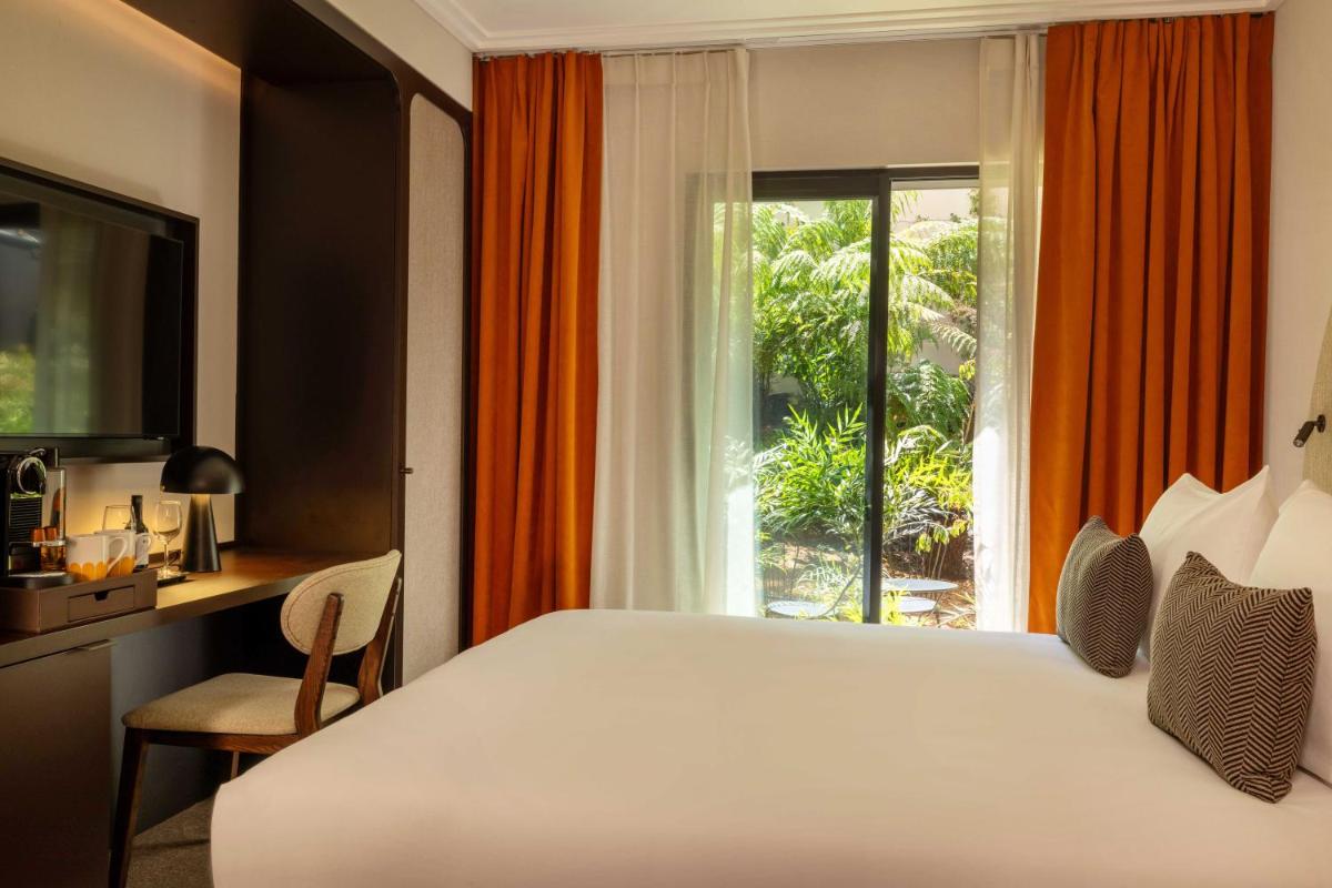 Un ou plusieurs lits dans un hébergement de l'établissement Belinda Hôtel & Spa