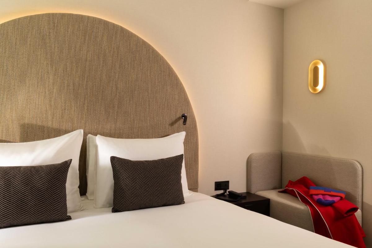Un ou plusieurs lits dans un hébergement de l'établissement Belinda Hôtel & Spa