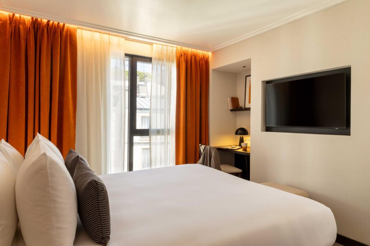 Télévision ou salle de divertissement dans l'établissement Belinda Hôtel & Spa