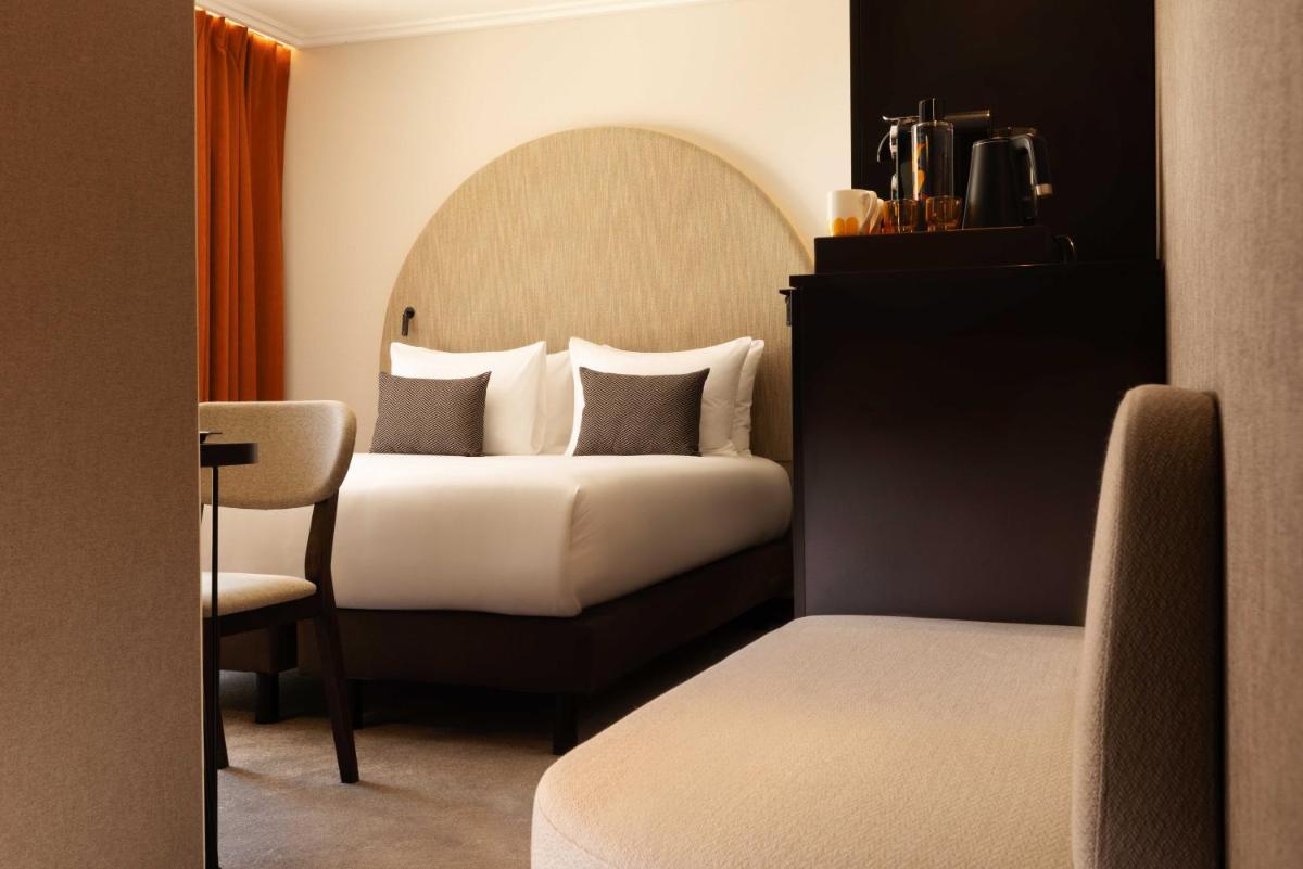 Un ou plusieurs lits dans un hébergement de l'établissement Belinda Hôtel & Spa
