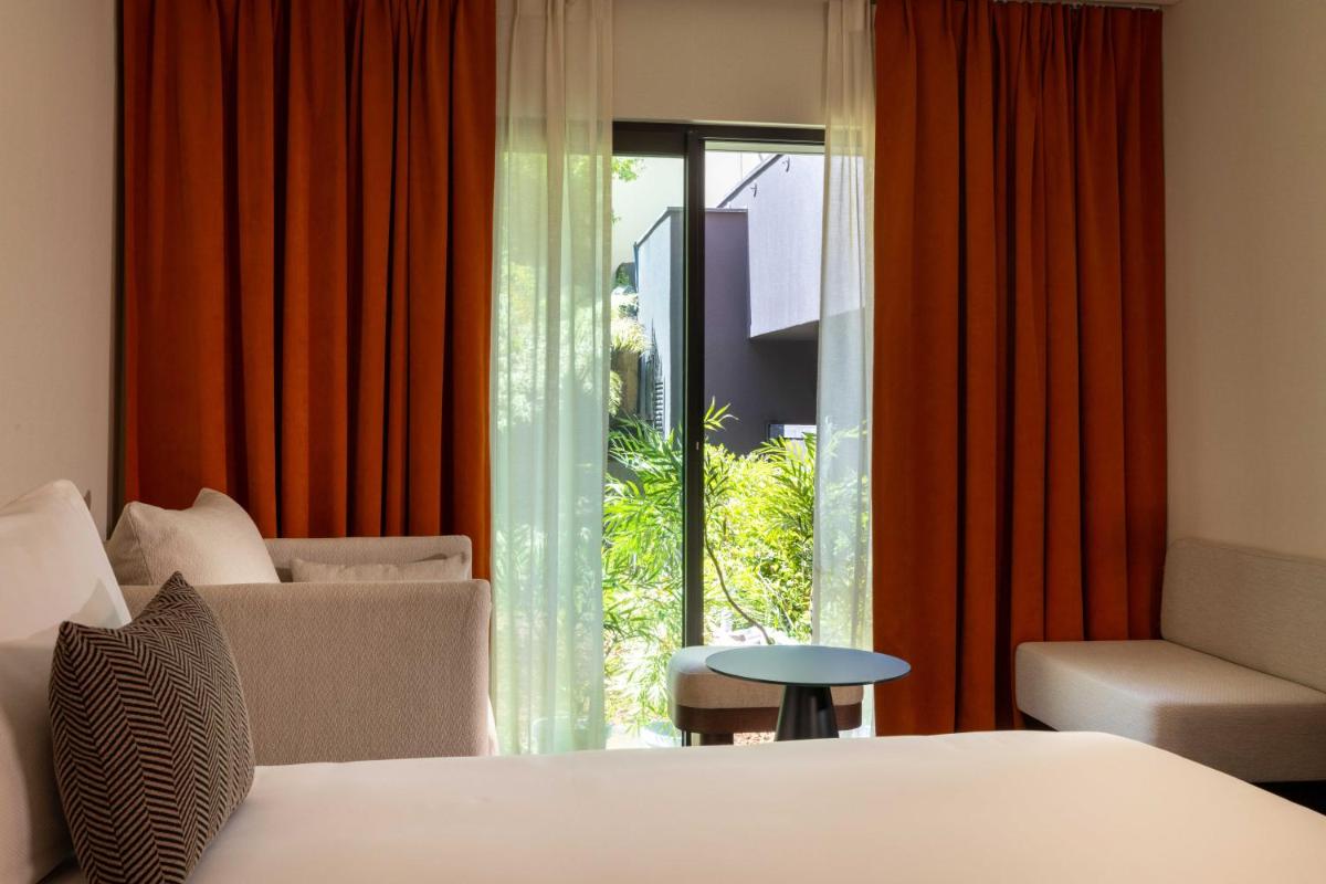 Un ou plusieurs lits dans un hébergement de l'établissement Belinda Hôtel & Spa
