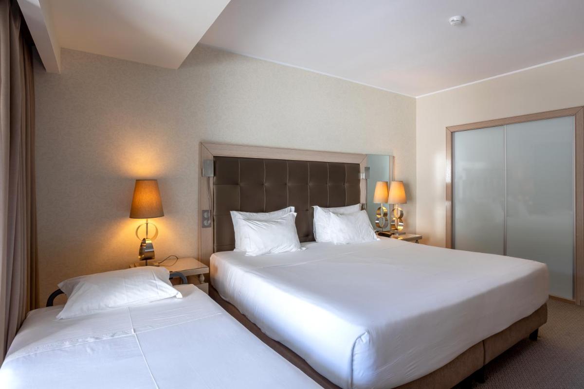 Uma cama ou camas num quarto em Hotel Porta do Sol Conference & SPA