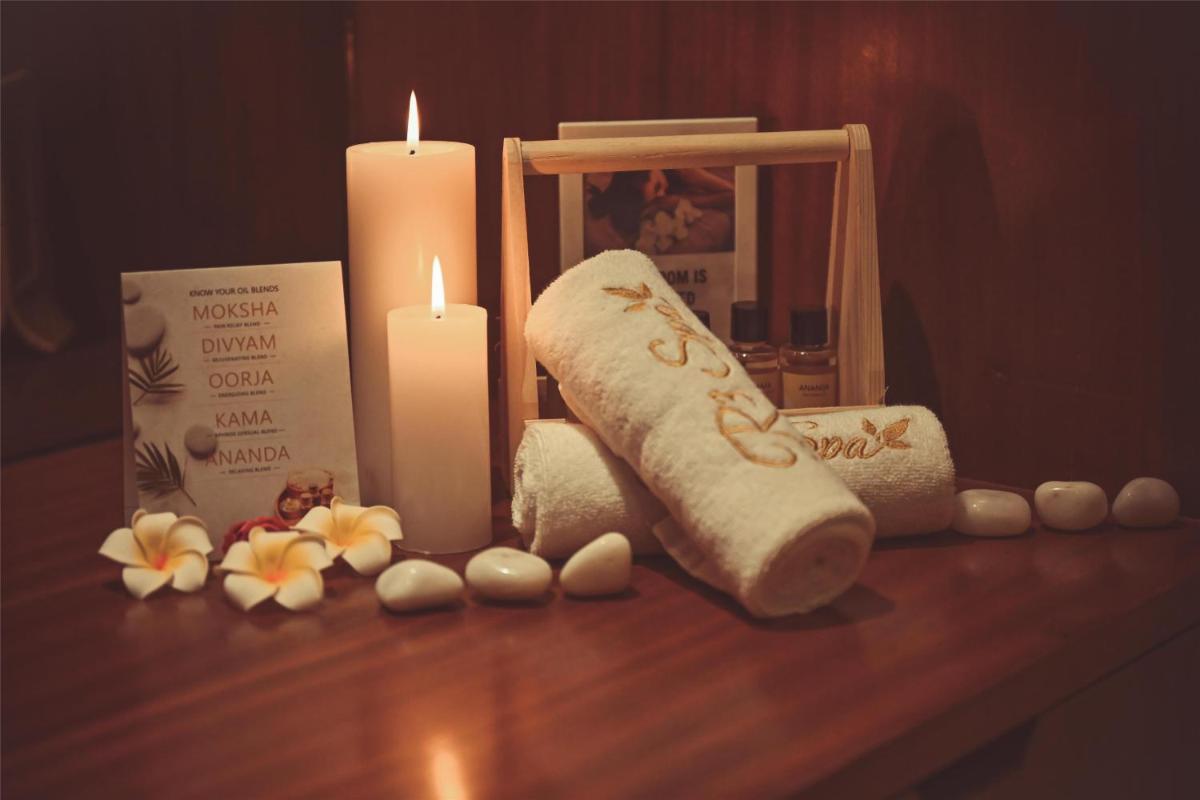 a group of candles and towels and flowers on a table at Radisson Jodhpur in Jodhpur