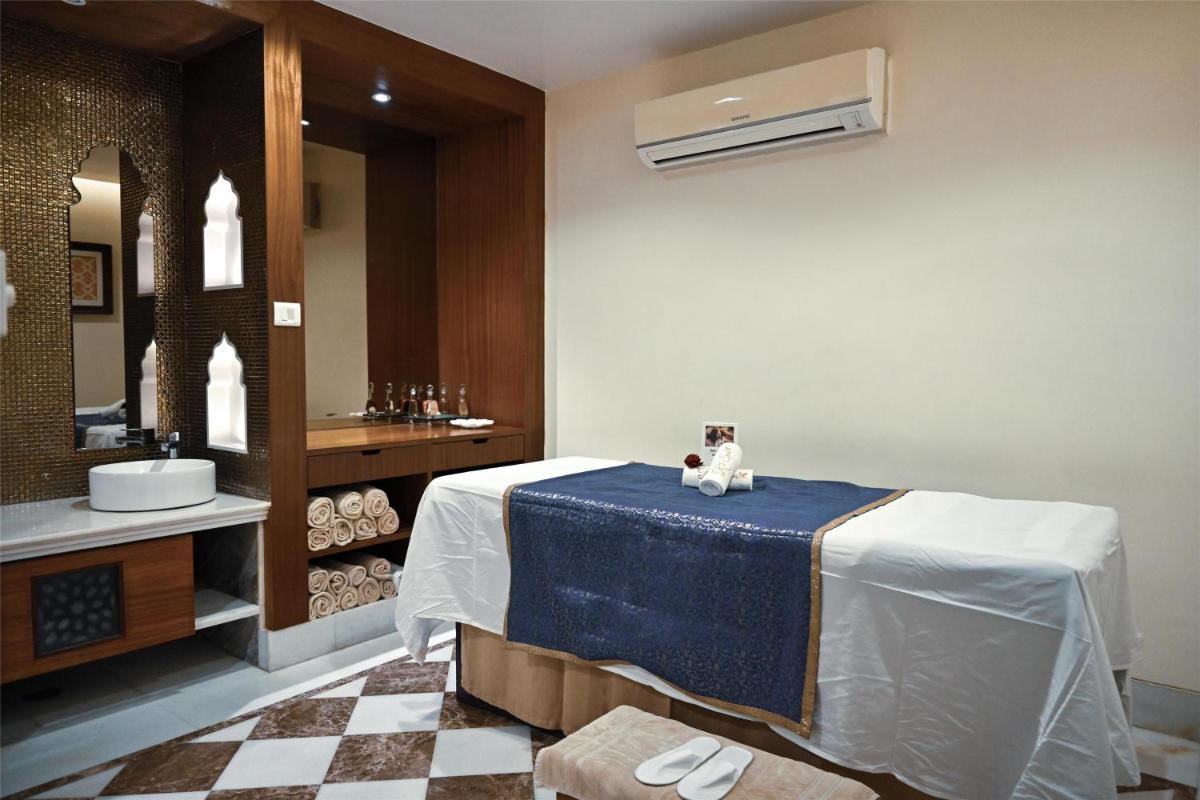 a bathroom with a bed with a cat sitting on it at Radisson Jodhpur in Jodhpur