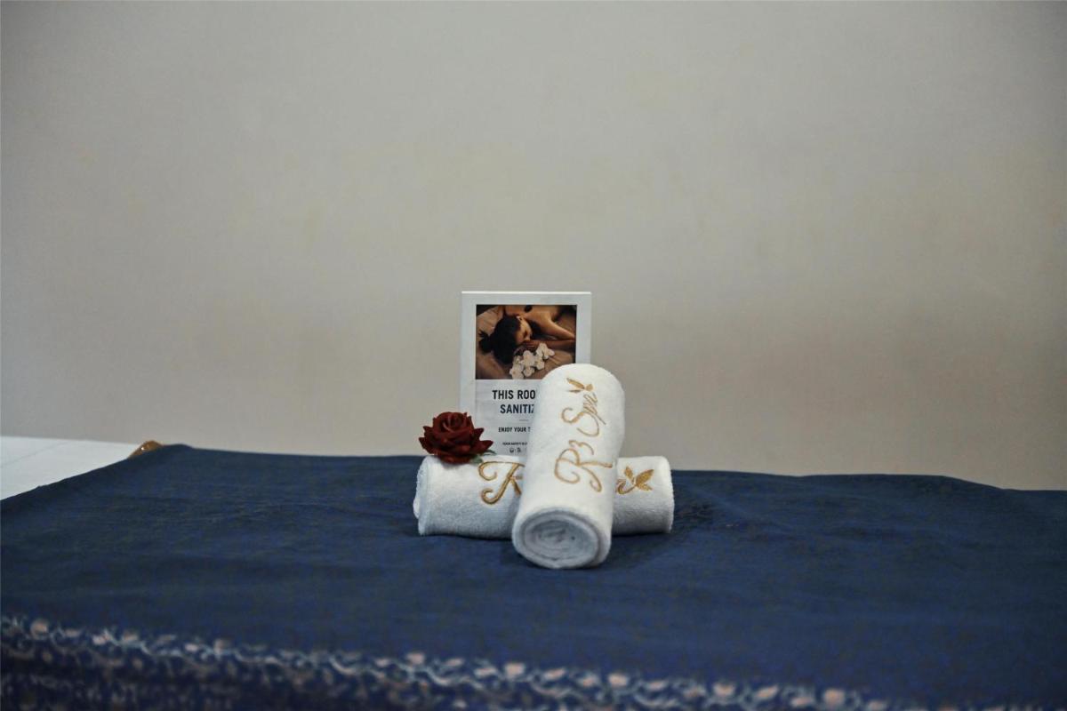a bed with two towels and a book on it at Radisson Jodhpur in Jodhpur