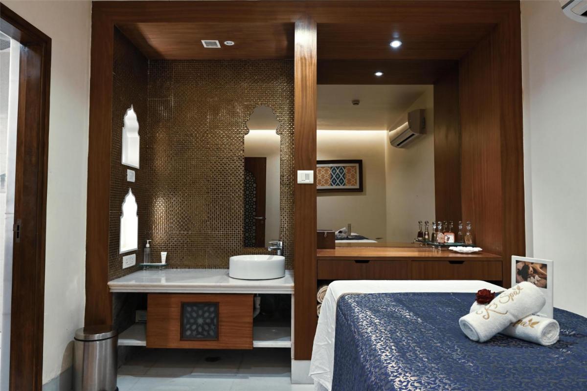 a bedroom with a bathroom with a sink and a bed at Radisson Jodhpur in Jodhpur